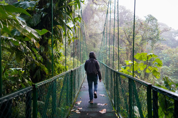 Man in Rain Jacket on a Hanging Bridge Walking in Monteverde, Costa Rica II