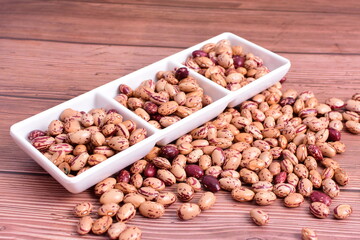 Natural bean grains
Phaseolus vulgaris on dark grain wood background
