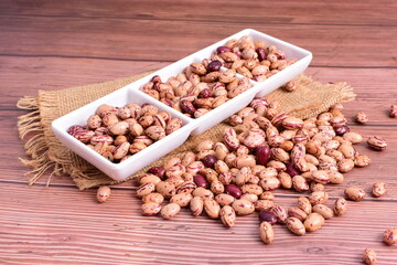 Natural bean grains
Phaseolus vulgaris on dark grain wood background