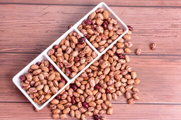 Natural bean grains
Phaseolus vulgaris on dark grain wood background