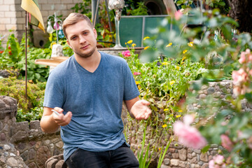 Portrait of an unshaven man resting in a city park.