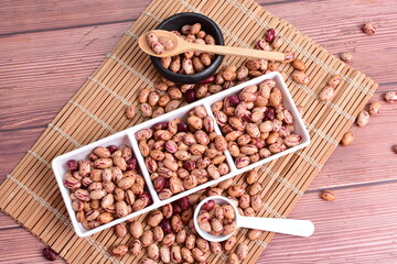 Natural bean grains
Phaseolus vulgaris on dark grain wood background