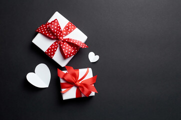 Valentines day gift boxes with hearts on black background