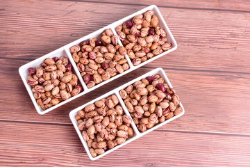 Natural bean grains
Phaseolus vulgaris on dark grain wood background