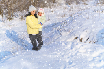 family portrait in the winter forest, mother and child, bright sunlight and shadows on the snow, beautiful nature