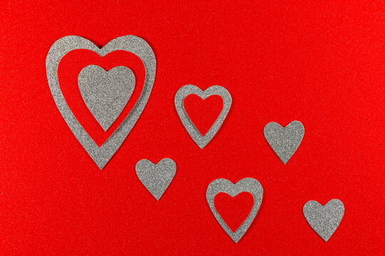 Red And Silver Hearts On Textured Red Background