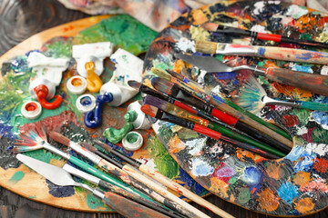 Paint brushes with drawings on an old background