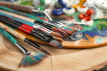 Brushes and paints for painting on an old background.