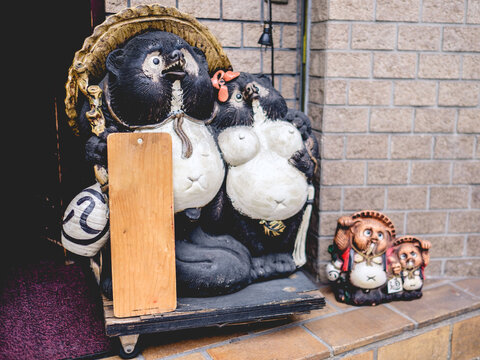Traditional tanuki (japanese raccoon dog) sculptures at streets oF Osaka, japan