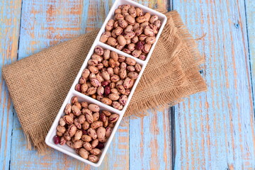 
Natural bean grains
Phaseolus vulgaris on blue grain wood background