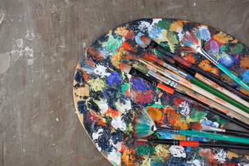 Brushes and paints for painting on an old background.