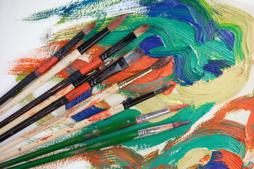 Brushes and paints for painting on an old background.
