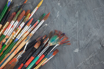 Brushes and paints for painting on an old background.