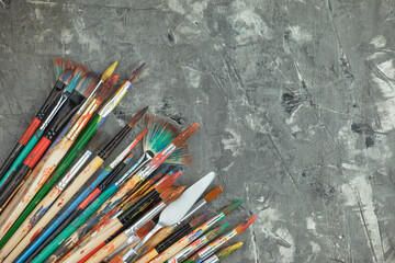 Paint brushes with drawings on an old background