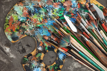 Brushes and paints for painting on an old background.