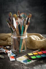 Brushes and paints for painting on an old background.