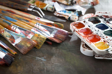 Multi-colored oil paints squeezed out of a tube onto a white sheet of paper.