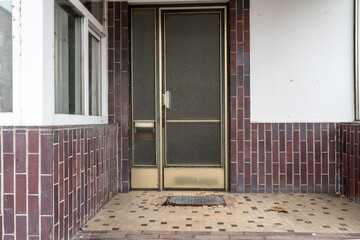 Glass door with brass fittings from the sixties