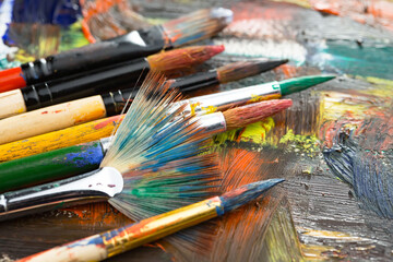 Brushes and paints for painting on an old background.