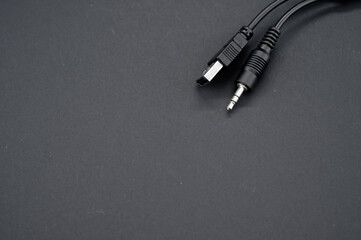 High angle shot of a USB aux cable against a black background