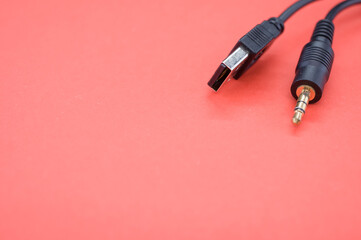 High angle shot of a USB aux cable isolated on a red background