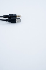 Vertical shot of a USB aux cable isolated on a gray background