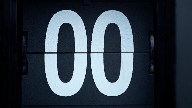 Close-up Flip clock White zero numbers on black background.