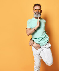 Healthy bearded man standing on one leg practicing yoga portrait