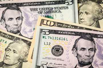 Closeup of $15 dollars with 10 and 5 dollar bills. Concept of 15 dollar federal minimum wage...