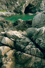 Rocks and grotto on the seashore, cloudy weather at sea, coastline of telyakovsky Bay Primorsky Krai, Russia.