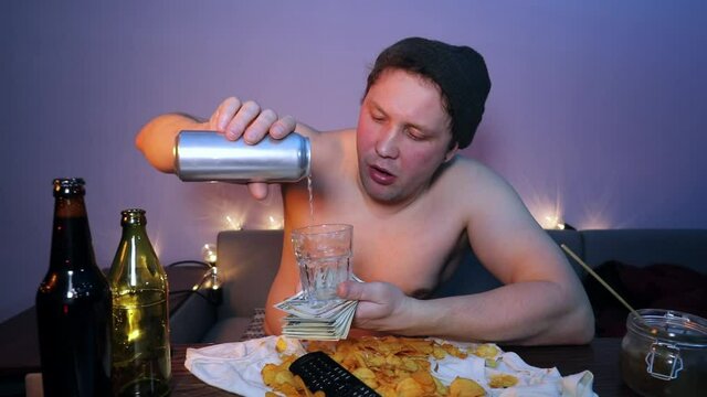 Redneck man pours beer on the money and happily counts the money
