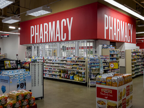 PORT CHARLOTTE, FLORIDA - JANUARY 22, 2021 : Pharmacy sign and over the counter drug section in an American grocery store.