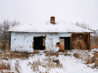 Concept with a crumbling house in the countryside - a symbol of social problems of small settlements at a time of economic instability
