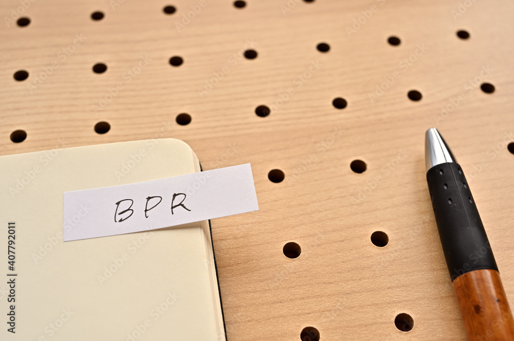 Poster a sticky note with bpr written on the edge of an open notebook on the punching board. that's an acro