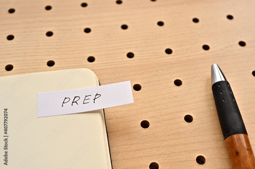 Aufkleber a sticky note with prep written on the edge of an open notebook on the punching board. that's an acr