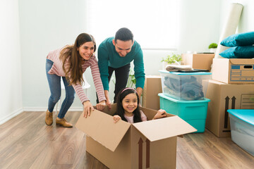 Joyful family playing in their new home while unpacking