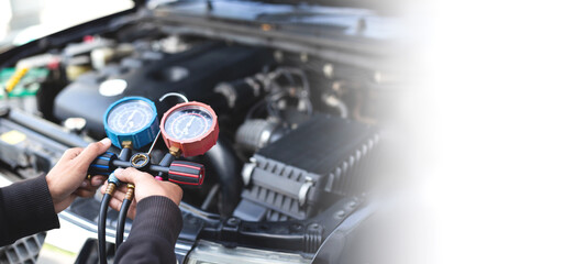 Obraz premium Car air conditioner check service, leak detection, fill refrigerant.Device and meter liquid cooling in the car by specialist technicians.