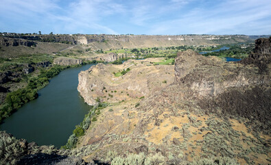 Winding Snake River flowing thru the pacific northwest in the summertime on a partly cloudy day