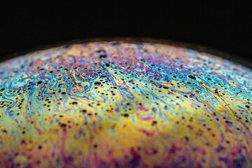 Detailed macro shot of a soap bubble - abstract and colorful pattern