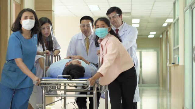 Group of medics or doctors Push Stretcher with Seriously Patient to Operating Room, Emergency Department