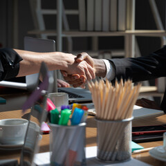 Obraz premium Close up hands shake of African businessman with Caucasian women.