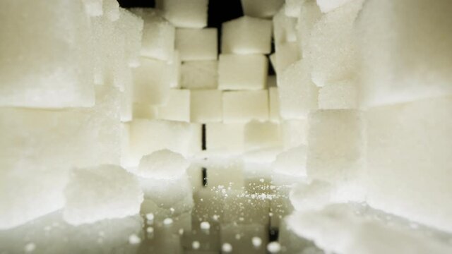 A large pile of beautiful white food sugar on a dark background.