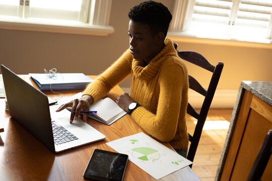 African american woman using laptop while working from home