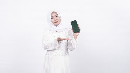 Asian muslim woman wearing prayer beads holding blank screen phone in white background