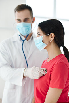 Doctor With A Stethoscope Examines A Patient Wearing A Medical Mask Breathing Lungs 