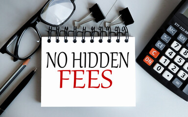 NO HIDDEN FEES, Text on a white notepad page on a gray background near the calculator