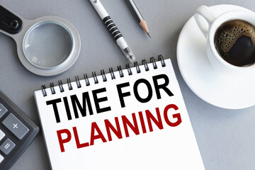 time for planning, Text on a white page of a notebook on a gray background near a magnifying glass and a cup of coffee