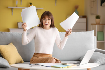 Stressed young woman trying to meet deadline at home