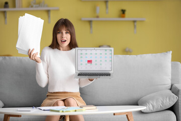 Stressed young woman trying to meet deadline at home