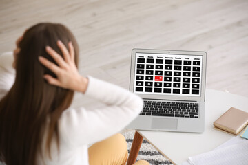 Stressed young woman trying to meet deadline at home